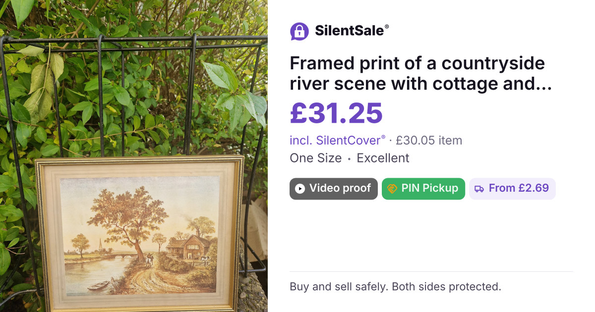 Framed print of a countryside river scene with cottage and trees