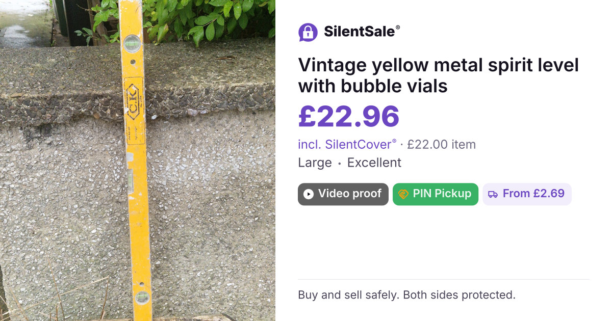 Vintage yellow metal spirit level with bubble vials